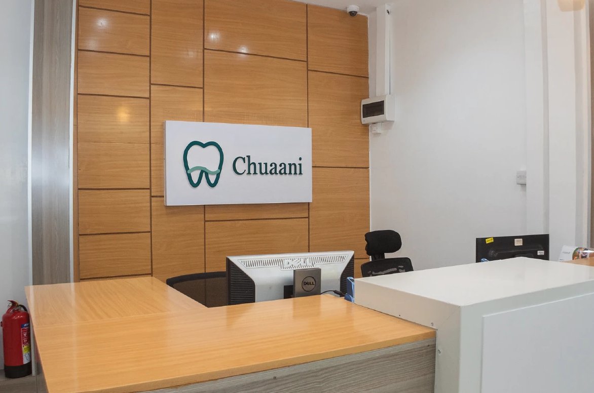 Chuaani reception desk with wood paneling and clinic signage